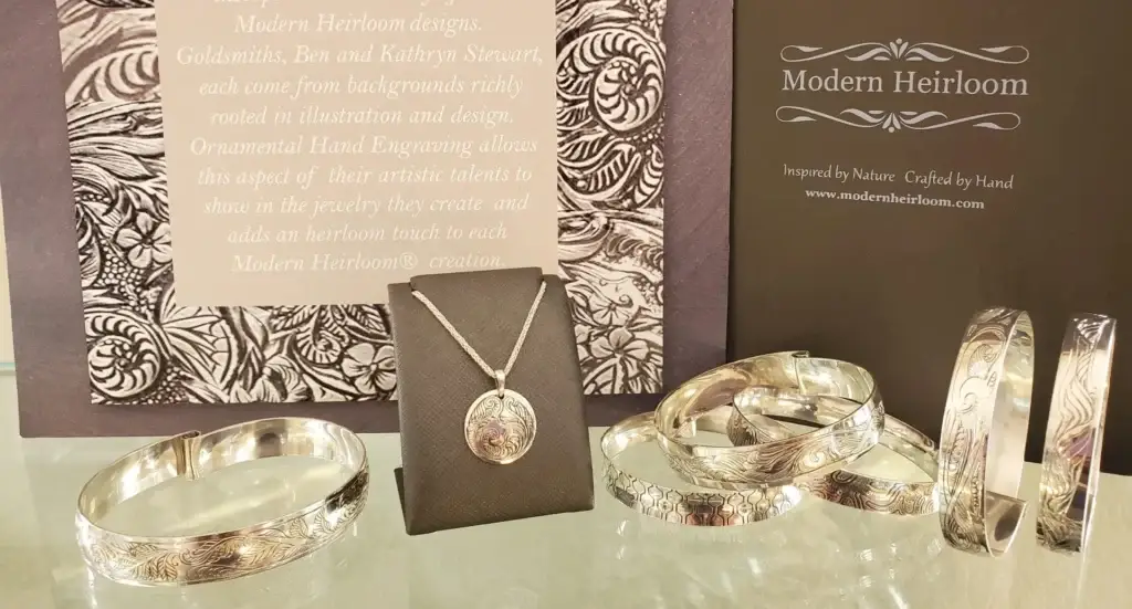 A curated group shot of handcrafted Modern Heirloom® jewelry pieces including rings and pendants.